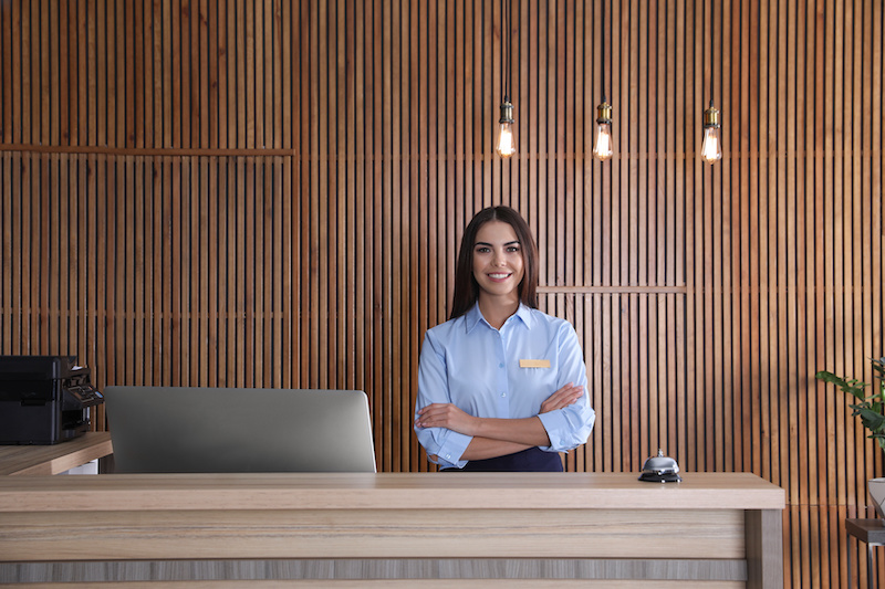 Portrait of receptionist at desk in lobby